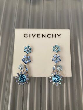 These Givenchy silver-tone earrings feature a floral design w/ blue crystal